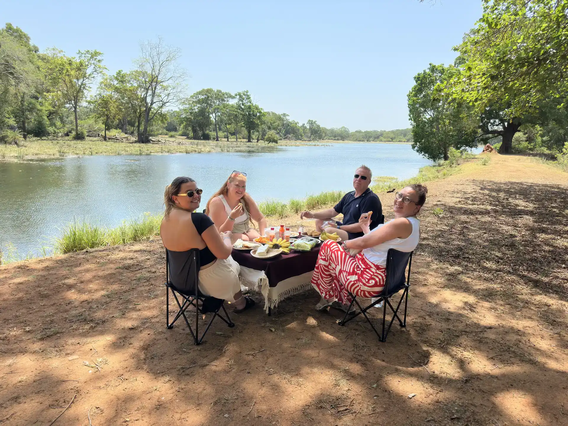 Safari guests enjoying a lakeside picnic, Udawalawe National Park, Sri Lanka